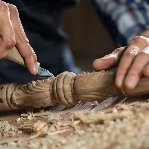 Individuelle Verzierungen Person, die Verzierungen in Holz schnitzt